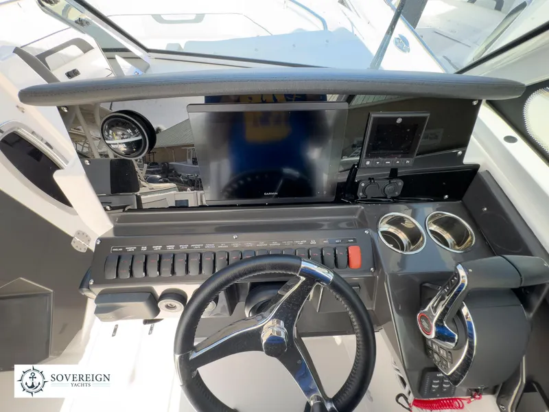 Slide: The Image of 2024 Blackfin 272 DC boat dashboard with steering wheel, controls, and display screens. - 31