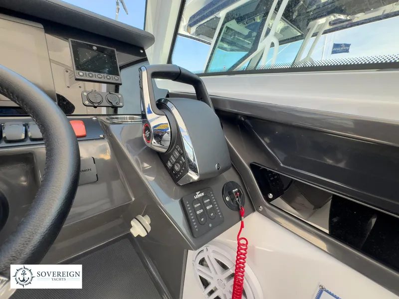 Slide: The Image of 2024 Blackfin 272 DC boat helm with modern controls and Sovereign Yachts logo. - 33