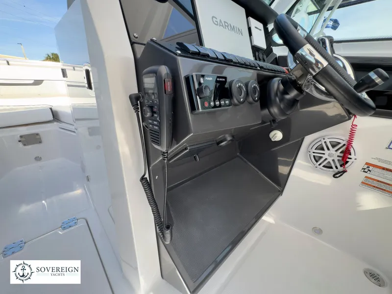 Slide: The Image of 2024 Blackfin 272 DC boat helm with Garmin navigation and Sovereign Yacht logo. - 34