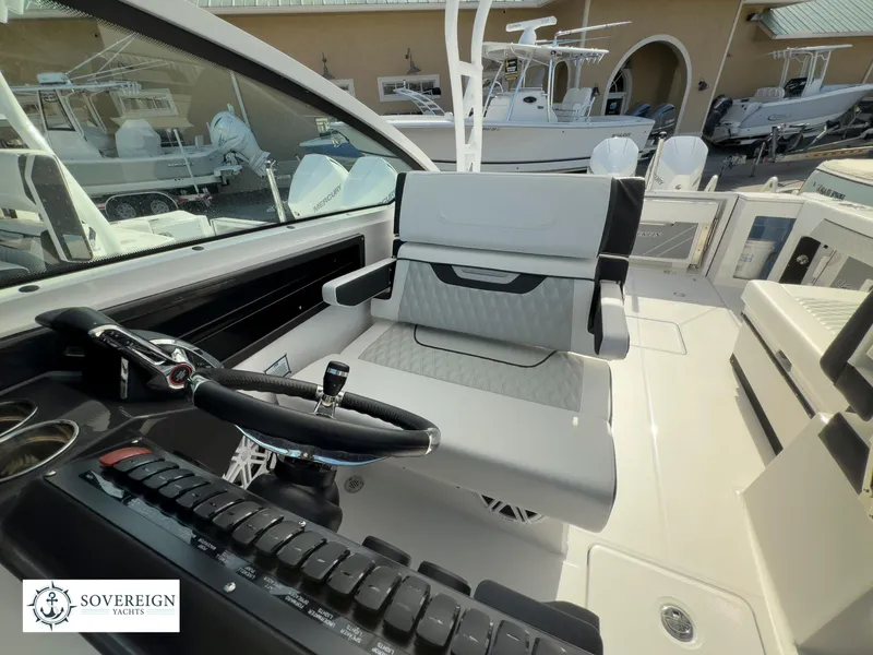 Slide: The Image of 2024 Blackfin 272 DC boat cockpit with steering wheel and seating. - 35
