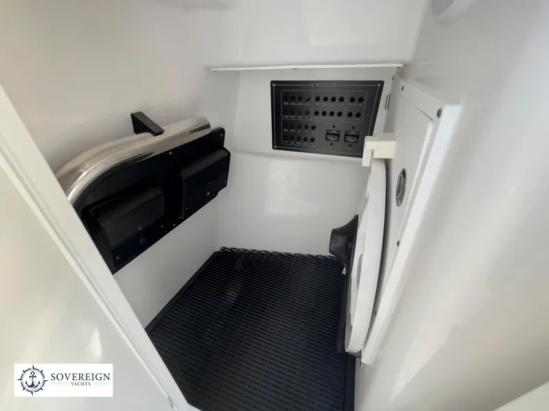 Slide: The Image of 2024 Blackfin 272 DC interior cabin with control panel and storage. - 36