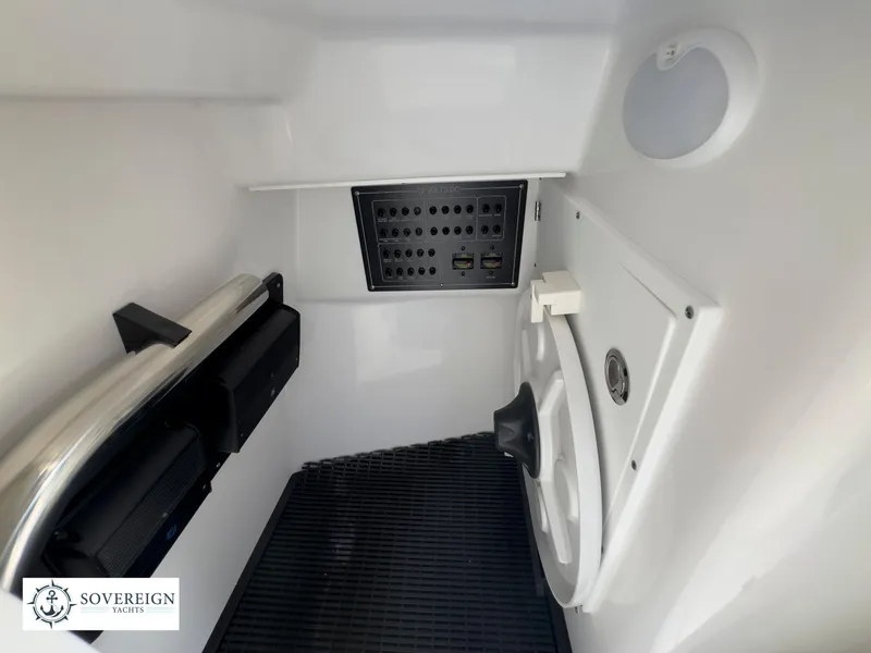 Slide: The Image of 2024 Blackfin 272 DC interior cabin with control panel and storage compartments. - 37