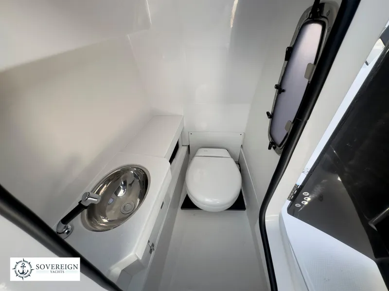 Slide: The Image of 2024 Blackfin 272 DC boat interior bathroom with sink and toilet. - 38
