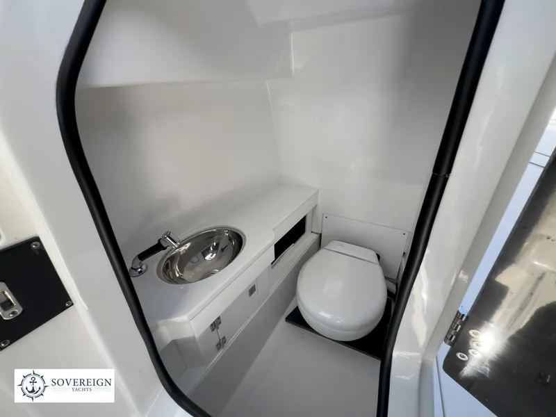 Slide: The Image of 2024 Blackfin 272 DC boat interior bathroom with sink and toilet. - 39