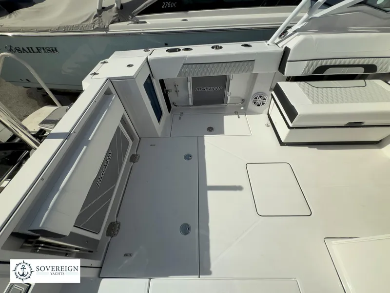 Slide: The Image of 2024 Blackfin 272 DC boat deck with seating and storage compartments. - 43