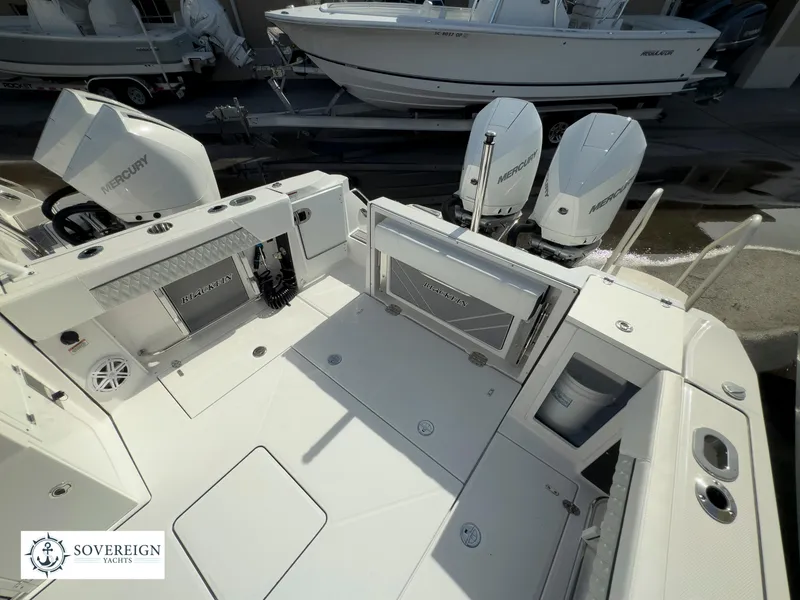 Slide: The Image of 2024 Blackfin 272 DC boat deck with twin Mercury engines. - 49