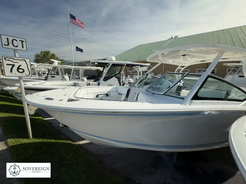 Slide: The Image of 2024 Blackfin 272 DC boats displayed at Sovereign Yacht dealership. - 6