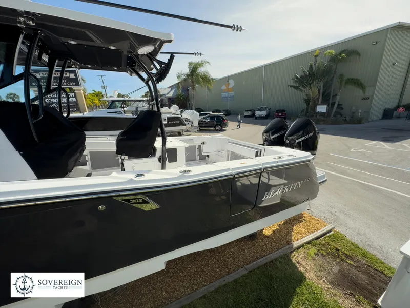Slide: The Image of 2024 Blackfin 302 boat displayed at Sovereign Yachts dealership. - 13
