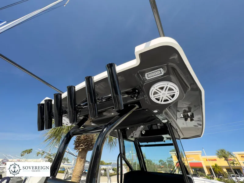 Slide: The Image of 2024 Blackfin 302 boat with rod holders and speakers, Sovereign Yachts logo. - 20