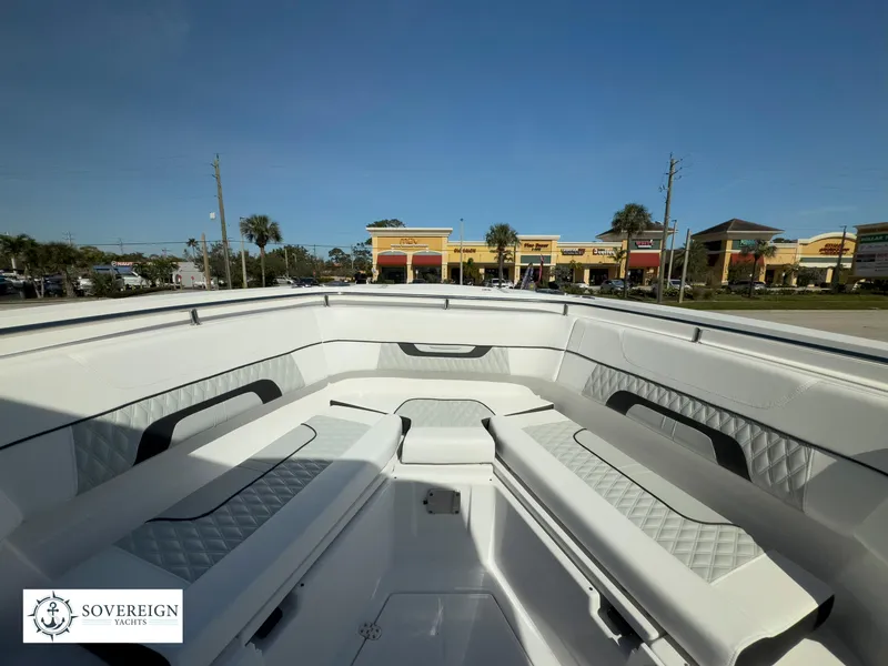 Slide: The Image of 2024 Blackfin 302 boat interior with white seating, Sovereign Yachts logo. - 23