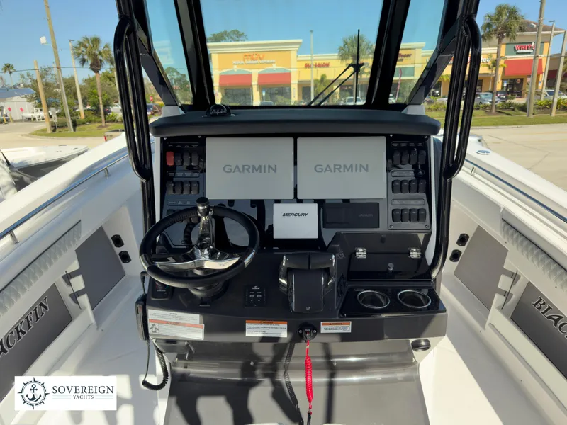 Slide: The Image of 2024 Blackfin 302 boat dashboard with Garmin navigation screens and Mercury controls. - 27
