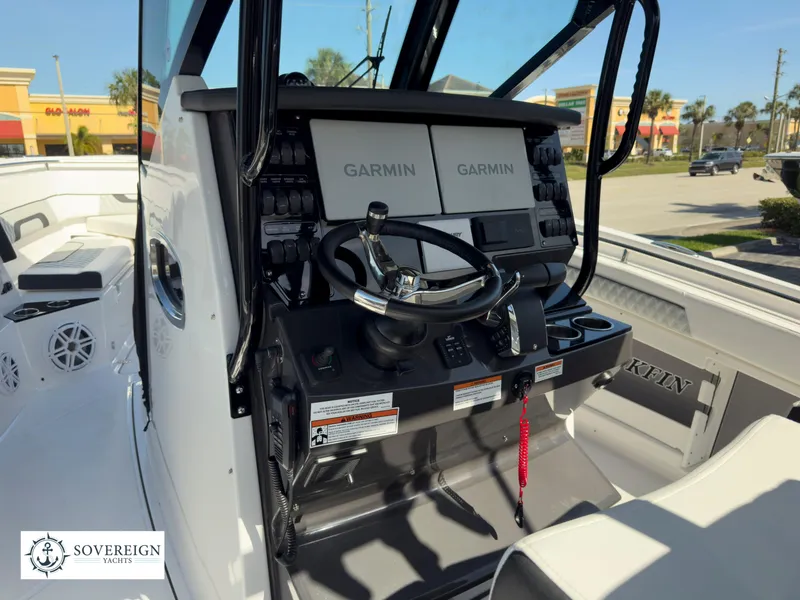 Slide: The Image of 2024 Blackfin 302 boat helm with dual Garmin displays and Sovereign Yachts logo. - 28