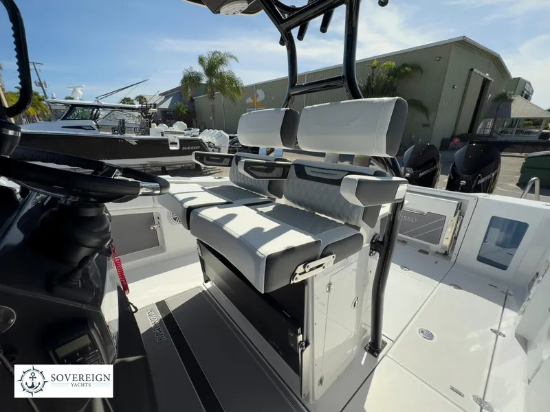 Slide: The Image of 2024 Blackfin 302 boat interior with seating and console, Sovereign Yacht logo. - 31