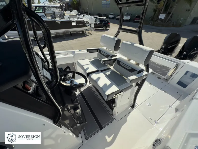 Slide: The Image of 2024 Blackfin 302 boat interior with seating and steering wheel, Sovereign Yachts logo. - 32