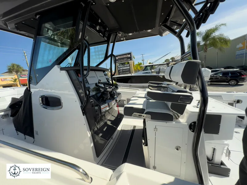 Slide: The Image of 2024 Blackfin 302 boat interior with helm and seating, displayed at Sovereign Yacht. - 34