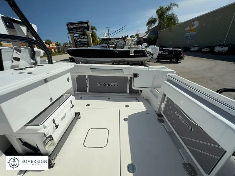 Slide: The Image of 2024 Blackfin 302 boat interior with storage compartments and seating. - 36