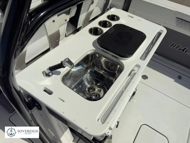 Slide: The Image of 2024 Blackfin 302 boat sink and workstation with cup holders. - 42