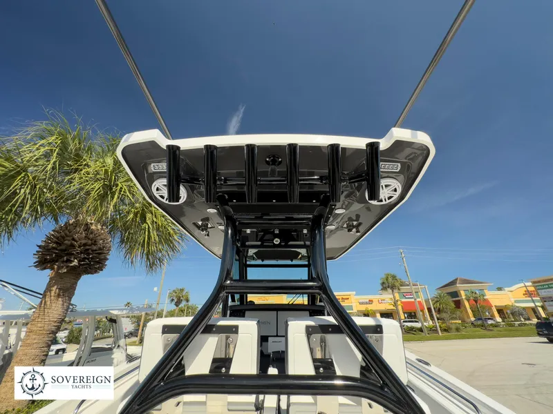 Slide: The Image of 2024 Blackfin 302 boat with T-top and rod holders, Sovereign Yachts logo. - 46