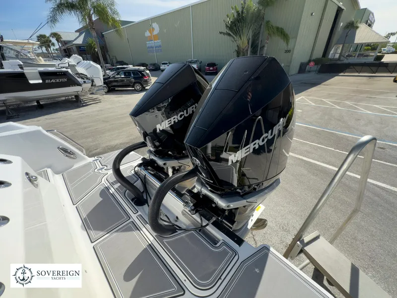 Slide: The Image of 2024 Blackfin 302 boat with twin Mercury outboard engines at a marina. - 49