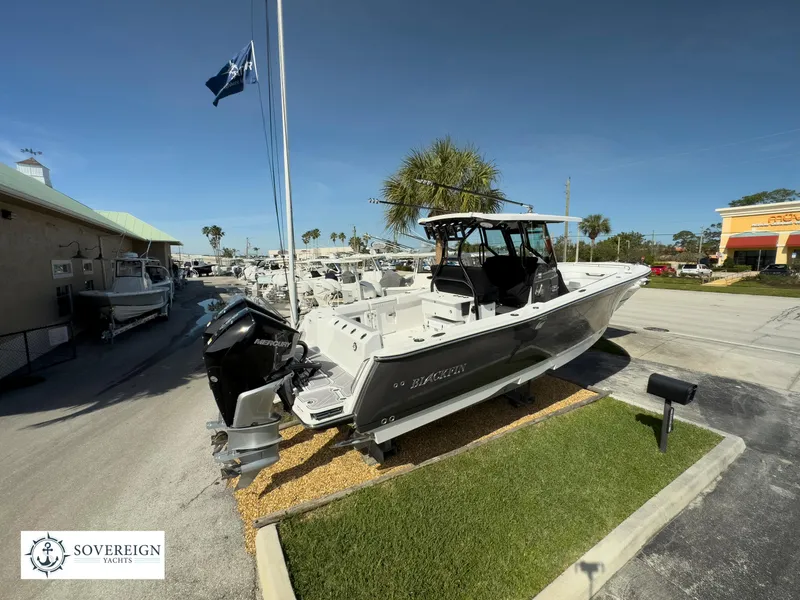 Slide: The Image of 2024 Blackfin 302 boat displayed at Sovereign Yacht dealership. - 7