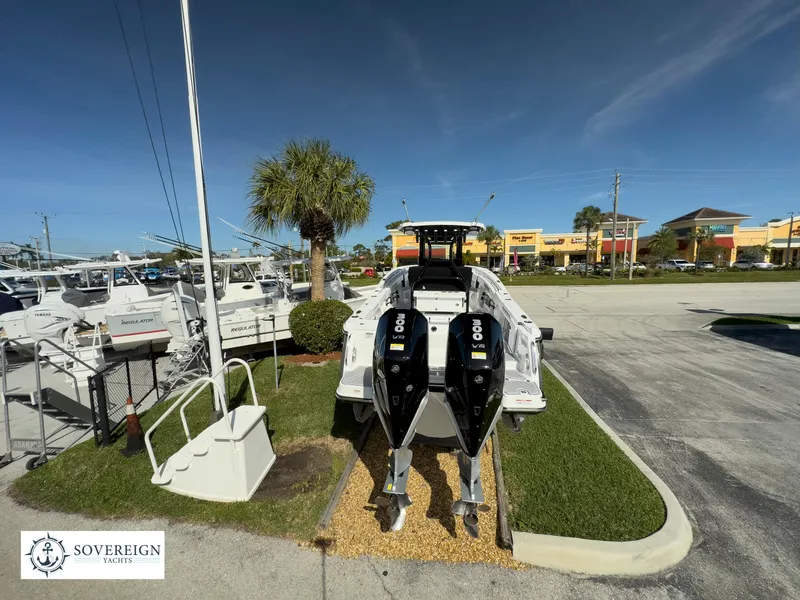 Slide: The Image of 2024 Blackfin 302 boat with twin outboard engines displayed at Sovereign Yacht dealership. - 8