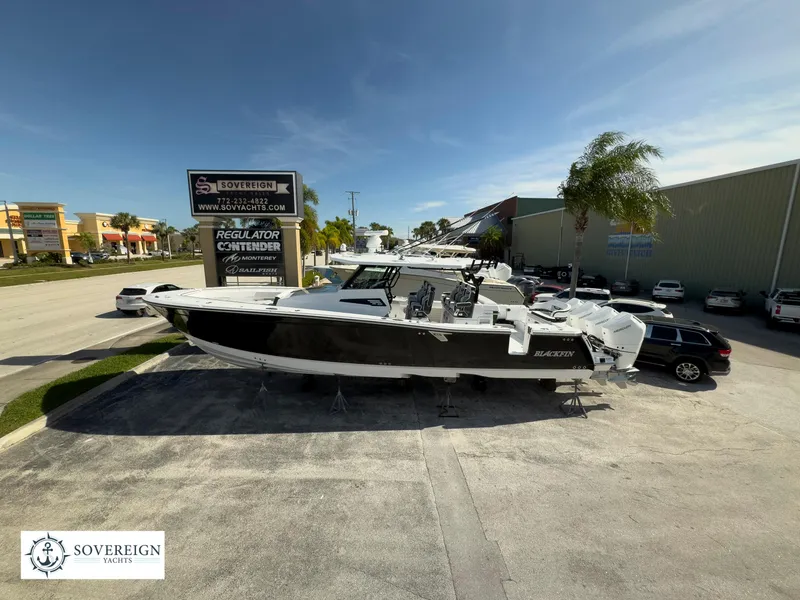 Slide: The Image of 2024 Blackfin 400 boat displayed at Sovereign Yachts dealership under clear blue sky. - 2