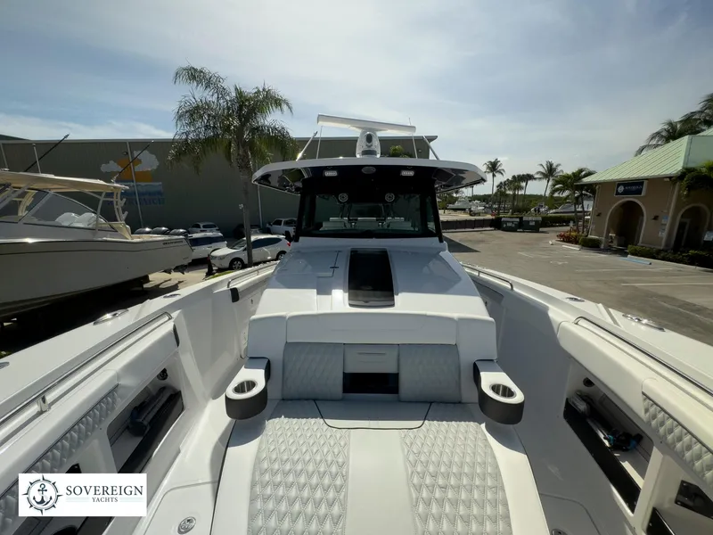 Slide: The Image of 2024 Blackfin 400 boat at a marina, front view with seating and console. - 23