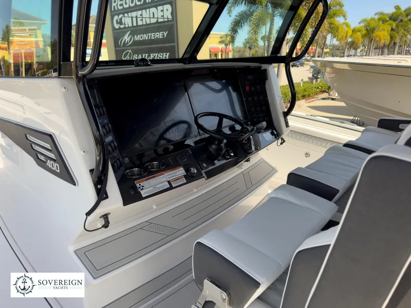 Slide: The Image of 2024 Blackfin 400 boat cockpit with dual steering wheels and modern controls. - 30