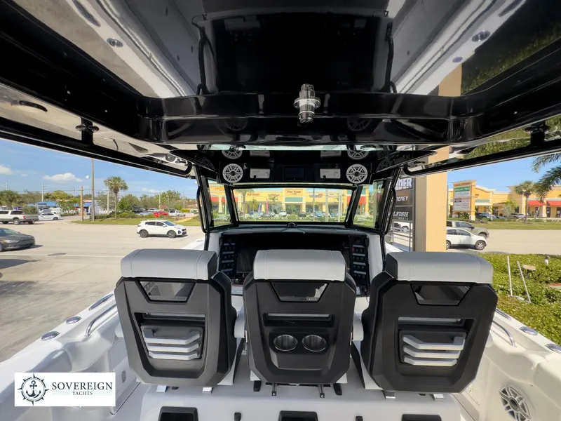 Slide: The Image of 2024 Blackfin 400 boat interior with three seats and dashboard, Sovereign Yachts logo. - 37