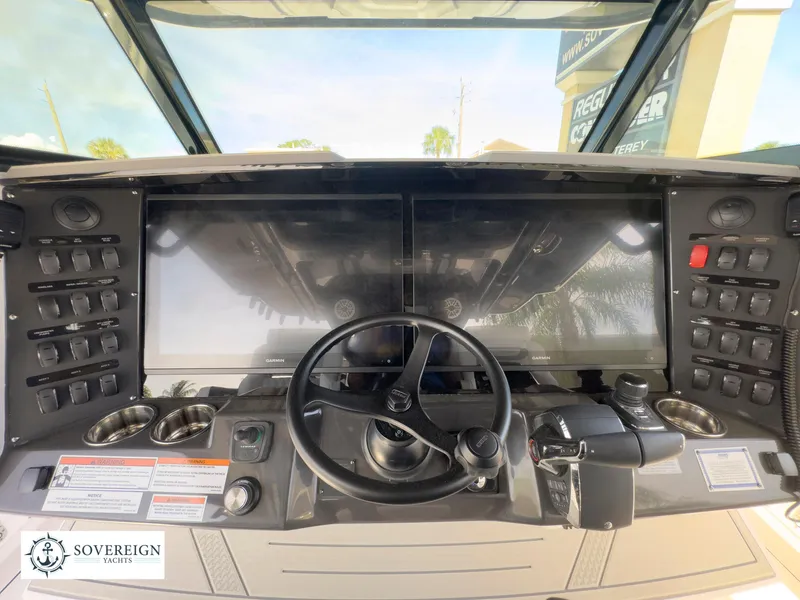 Slide: The Image of 2024 Blackfin 400 boat helm with dual screens and control panel. - 44