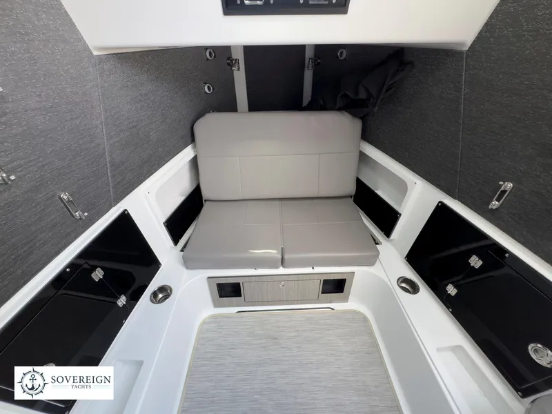 Slide: The Image of 2024 Blackfin 400 boat interior with gray seating and storage compartments. - 48