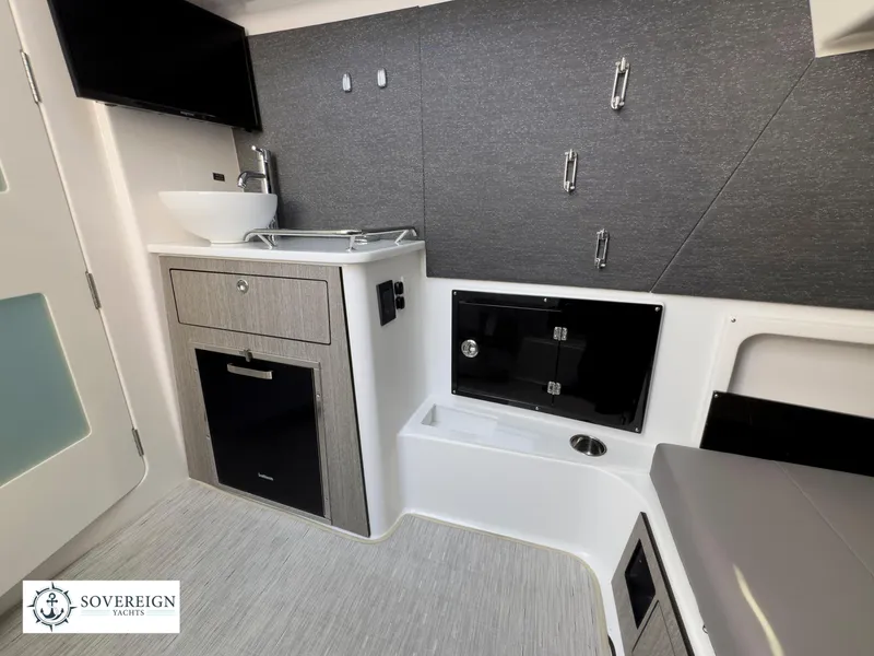 Slide: The Image of Modern interior of 2024 Blackfin 400 boat with sleek cabinetry and compact sink. - 49