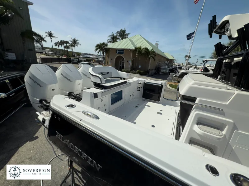 Slide: The Image of 2024 Blackfin 400 boat with twin Mercury outboard engines at a marina. - 8