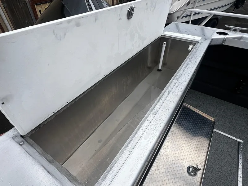 Slide: The Image of 2024 Thunder Jet 21 Chinook OS boat storage compartment with open lid. - 18