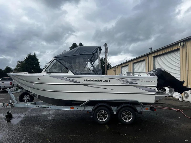 Slide: The Image of 2024 Thunder Jet 21 Chinook OS boat on trailer, parked outdoors. - 2