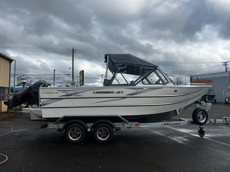 Slide: The Image of 2024 Thunder Jet 21 Chinook OS boat on a trailer under cloudy skies. - 5