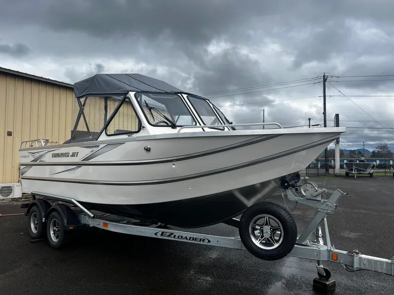 Slide: The Image of 2024 Thunder Jet 21 Chinook OS boat on trailer under cloudy sky. - 6