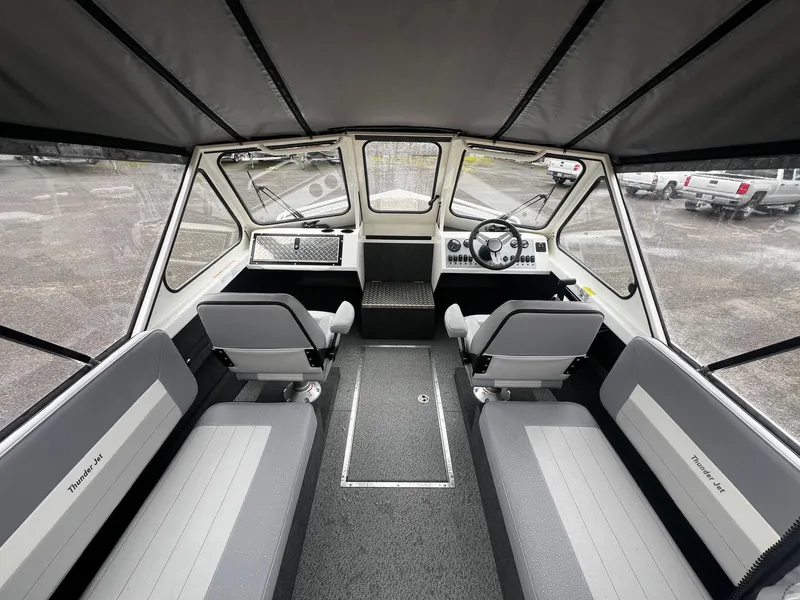 Slide: The Image of 2024 Thunder Jet 21 Chinook OS boat interior with seating and steering console. - 7