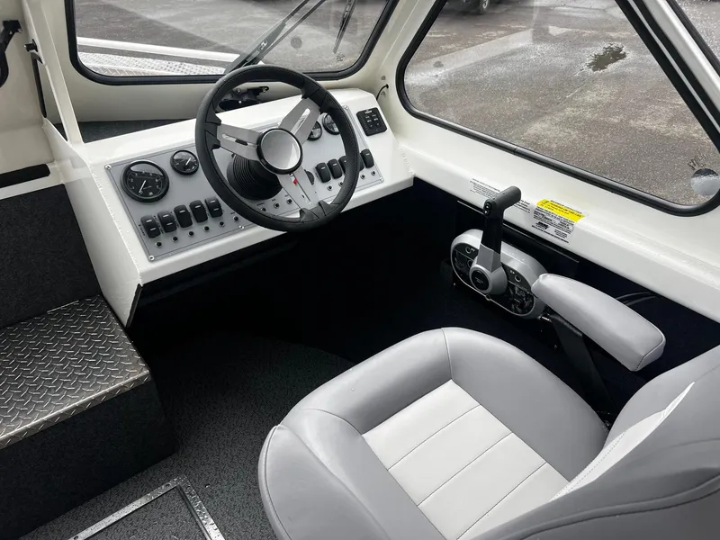 Slide: The Image of 2024 Thunder Jet 21 Chinook OS boat interior with steering wheel and control panel. - 8