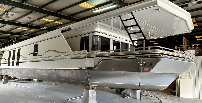 The Image of 2005 Fantasy 18 x 80 houseboat in a warehouse, side view. - 1