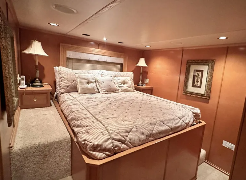 Slide: The Image of Luxurious bedroom in a 2005 Fantasy 18 x 80 houseboat with cozy lighting and elegant decor. - 14