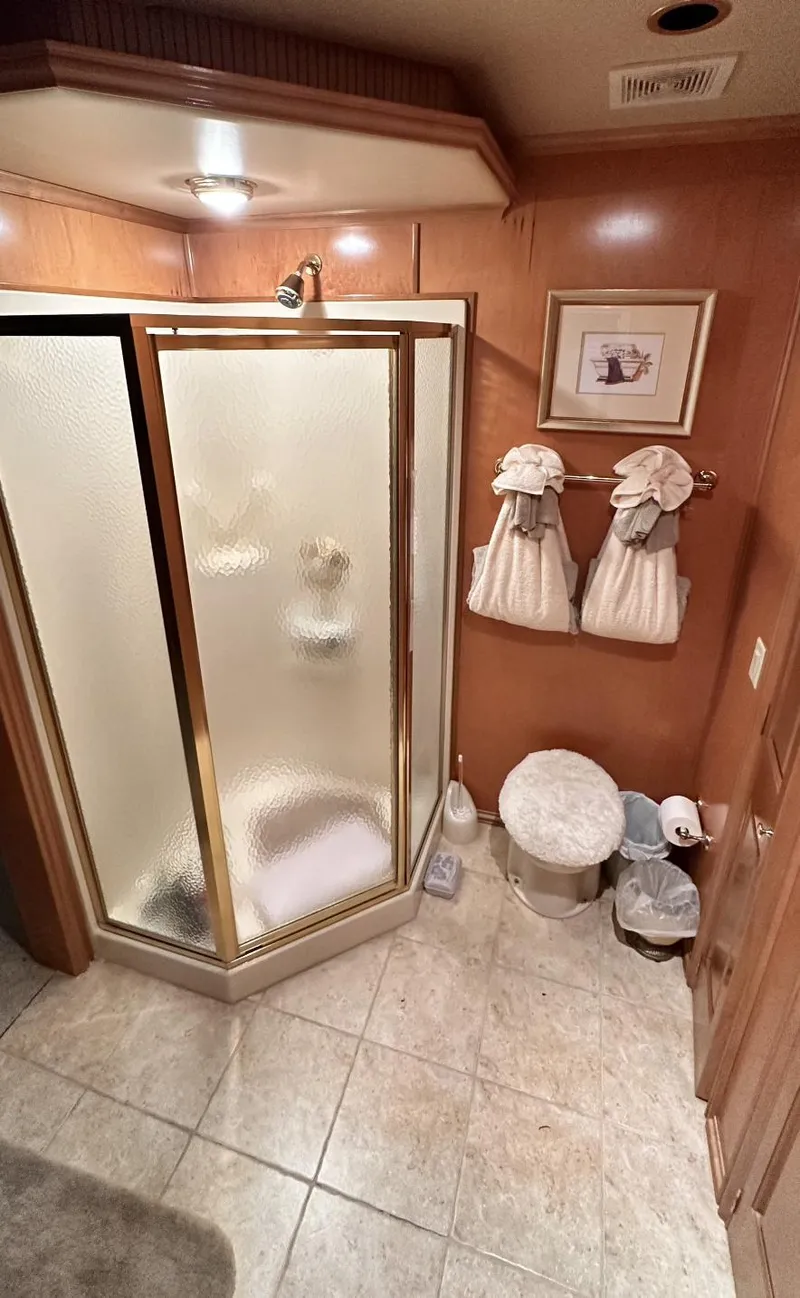 Slide: The Image of 2005 Fantasy 18 x 80 bathroom with glass shower, tiled floor, and decorative towels. - 16