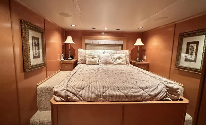Slide: The Image of Luxurious bedroom in a 2005 Fantasy 18 x 80 houseboat with cozy lighting and elegant decor. - 17
