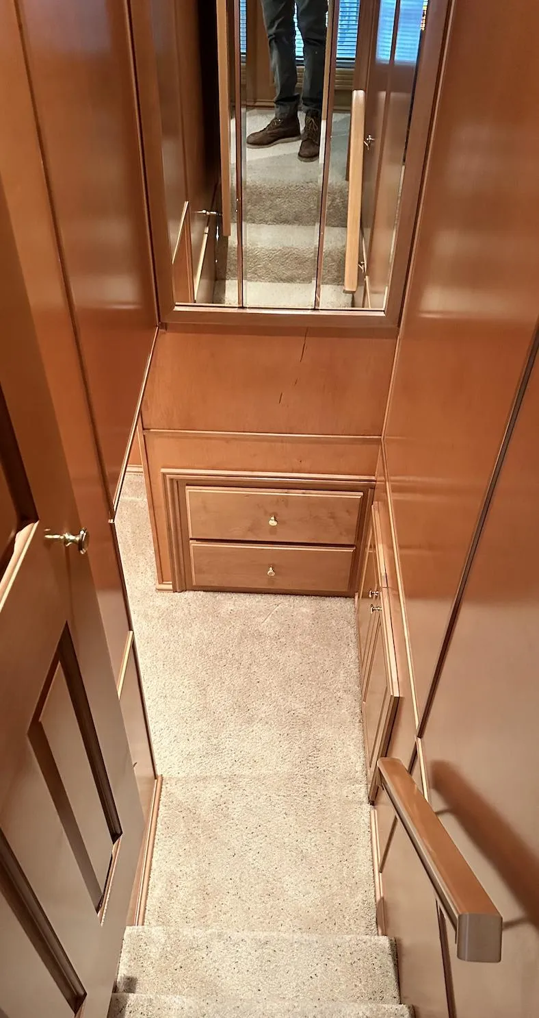 Slide: The Image of Staircase in 2005 Fantasy 18 x 80 houseboat with wooden paneling and carpet. - 18