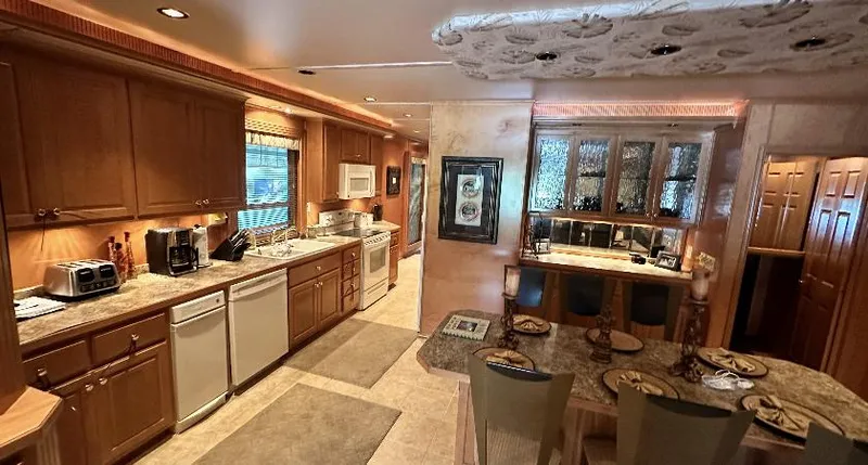 Slide: The Image of Luxurious kitchen and dining area in a 2005 Fantasy 18 x 80 houseboat. - 22