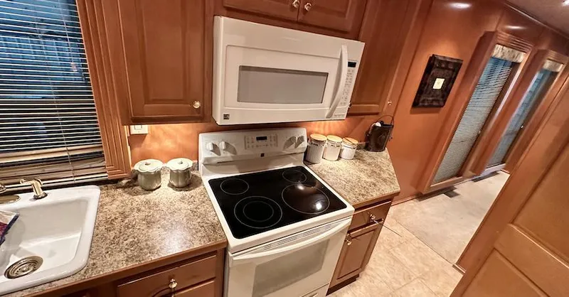Slide: The Image of Modern kitchen in a 2005 Fantasy 18 x 80 houseboat with stove, microwave, and sink. - 23