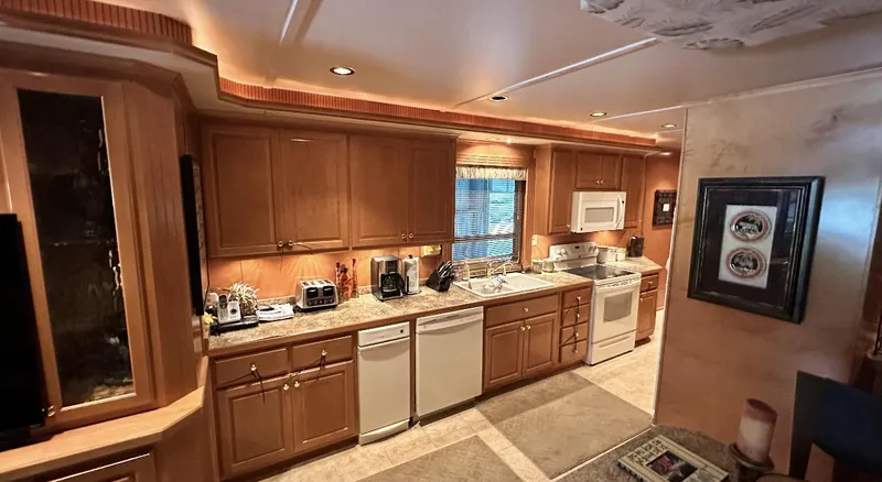 Slide: The Image of Spacious kitchen in a 2005 Fantasy 18 x 80 houseboat with wooden cabinets and modern appliances. - 25