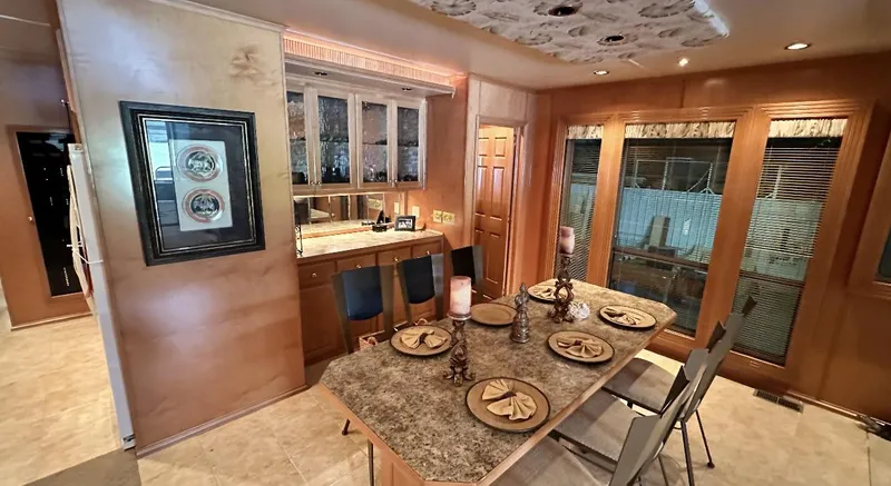 Slide: The Image of Luxurious dining area in a 2005 Fantasy 18 x 80 houseboat with elegant decor. - 27