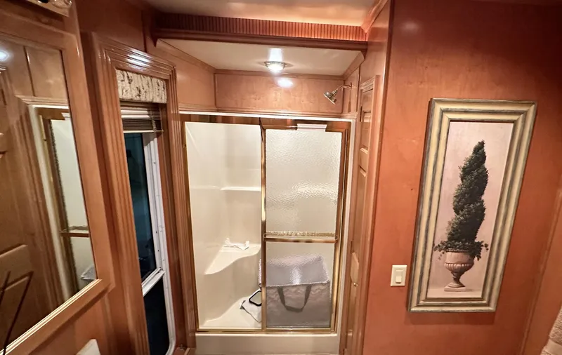 Slide: The Image of 2005 Fantasy 18 x 80 bathroom with shower, wooden cabinets, and framed artwork. - 8