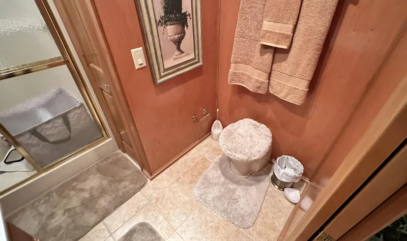 Slide: The Image of 2005 Fantasy 18 x 80 houseboat bathroom with shower, toilet, and beige decor. - 9